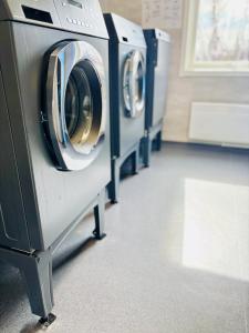 a row of washing machines in a laundry room at Frost Longstay Lakeside in Kiruna
