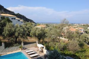 a villa with a swimming pool and a resort at Pirofani Villa Apartments in Apolpaina