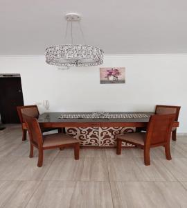 a dining room table with chairs and a chandelier at Al Rehab city, Avenue Mall group129 bulding7 5th, CASA MIA in New cairo