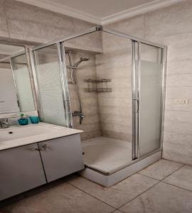 a bathroom with a shower and a sink at Al Rehab city, Avenue Mall group129 bulding7 5th, CASA MIA in New cairo +9 photos