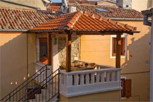 a balcony of a house with a roof at Krk centar in Krk