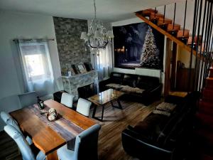 a living room with a dining table and a christmas tree at Μιτάτο Οίτη in Pavliani