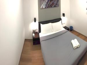a bedroom with a large white bed with white pillows at OYO 89492 Carlton Inn Bukit Ubi in Kuantan +75 photos