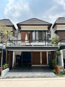 a house with a courtyard in front of it at The Nook by Benih in Seturan