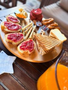 a plate with bread and cheese and crackers on a table at Lidori Mani in Akhíllion +31 photos