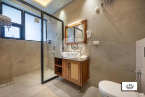 a bathroom with a shower and a sink and a mirror at Maverick Hills Kasauli in Kasauli +105 photos