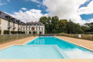 an empty swimming pool in front of a building at Maya - Piscine - Calme - Parking in Baden +6 photos