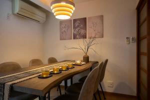 a dining room table with glasses of orange juice on it at Gujo BASE in Gujo