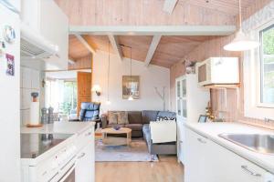 a kitchen and living room with a couch at 16608-1-Farevejle-Horager-8 in Kårup