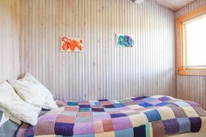 a bedroom with a bed with a colorful blanket on it at 16608-1-Farevejle-Horager-8 in Kårup