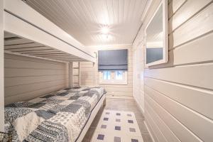 a small bedroom with a bed in a house at Lavi Chalet by Aavalevi in Levi