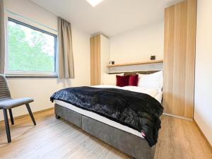 Un pat sau paturi într-o cameră la Chalet No. 156 Wagrain