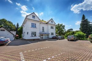 a white building with a parking lot in front of it at Marie - Luisa in Prague