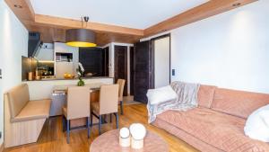 a living room with a couch and a table at ASAI210-6-2 Appartement 4 étoiles - Les Saisies - 6 personnes in Les Saisies
