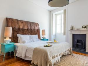 a bedroom with a fireplace and a bed at Down2Town B&B in Porto