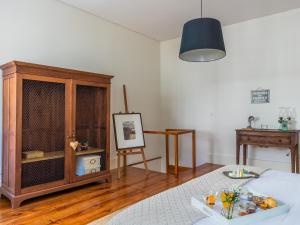 a living room with a wooden table and a lamp at Down2Town B&B in Porto