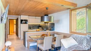 a kitchen and living room with a table and chairs at ASAI210-7-1 Appartement 4 étoiles - Les Saisies - 8 personnes in Les Saisies