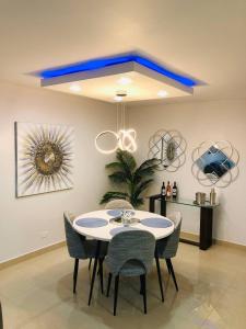 comedor con techo azul, mesa y sillas en Isla Verde Beachfront Retreat with parking, en San Juan