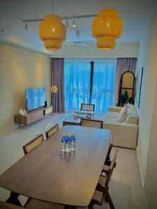 a living room with a table and a living room with a couch at Klcc suite by Agile Residence in Kuala Lumpur +45 photos