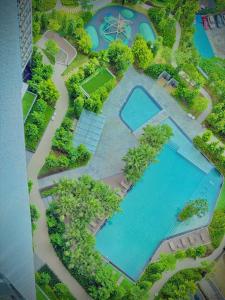 an overhead view of a swimming pool with trees and water at Klcc suite by Agile Residence in Kuala Lumpur