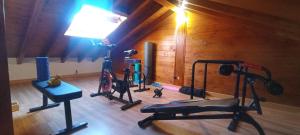 a gym with two bikes and a lamp in a room at Casa entre "Mar y Montaña" centro de Cantabria, terraza, ajardinada, amplia y luminosa, hasta 10 personas in Puente San Miguel