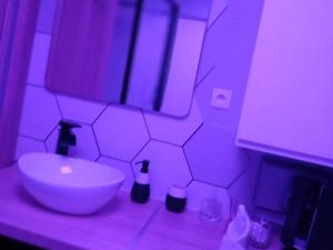 a bathroom with a white sink and a mirror at Heaven Loft in Yvetot