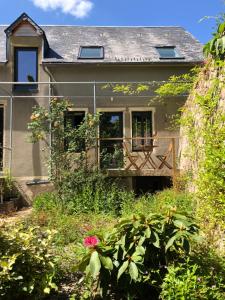 a house with a garden in front of it at Les gites du renard souriant in Cussy-en-Morvan