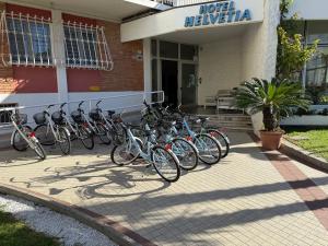 a group of bikes parked in front of a building at Hotel Helvetia in Grado