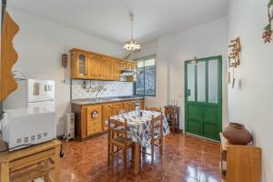 a kitchen with a table and a green door at Apartamento Nayara A in Calera