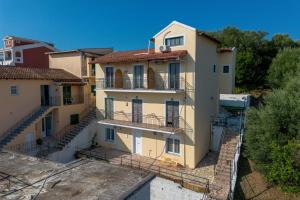 a building with balconies on the side of it at Gavriil Maisonette G3 in Corfu