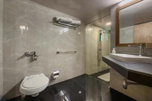 a bathroom with a toilet and a sink at SaffronStays Hidden Branches -3BR pet-friendly villa with infinity pool & forest views in Khandala in Lonavala +31 photos