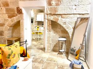 a living room with a stone wall at Antica Pietra in Polignano a Mare +104 photos
