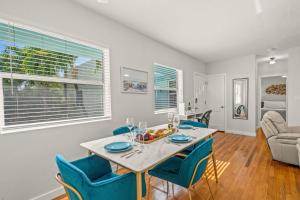 a dining room with a table and blue chairs at Condo by the Beach King Bed Lush Patio w BBQ Breakers Key Seven H0MES in Fort Lauderdale +11 photos