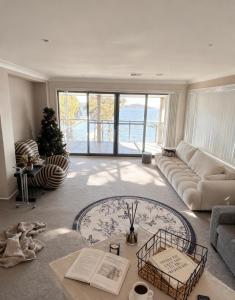 a living room with a couch and a christmas tree at Bluewater sanctuary in Tascott +21 photos