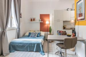 a small bedroom with a bed and a desk at Residenza Il Torrione in Iesi