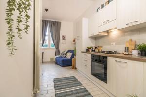 a kitchen with a stove and a couch in a room at Residenza Il Torrione in Iesi