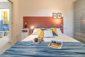 a bedroom with a bed with a blue blanket at Residenza Il Torrione in Iesi +23 photos