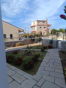 a stone walkway in front of a building at Μαρία 4 in Káto Almirí +21 photos