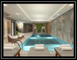 a large swimming pool in a room with chairs at Lions Royal Hotel in Istanbul