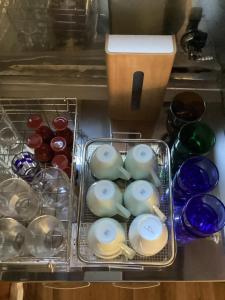 a drawer with a bunch of bowls and a blender at guest house DEER MIYAJIMA in Hatsukaichi