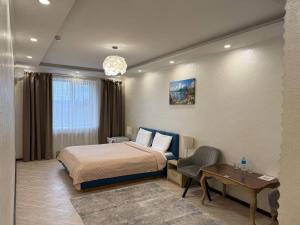 a bedroom with a bed and a table and a desk at Hotel-Restaurant Complex Relax in Zhytomyr