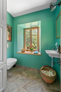 a green bathroom with a sink and a window at Abitaziun Acla Albanatscha - Silvaplana in Silvaplana +27 photos