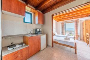 a kitchen with a sink and a bed in a room at Gavriil Maisonette G3 in Corfu +25 photos