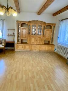an empty room with a large wooden cabinet at Foistovic Ranč in Staré Sedlo +18 photos