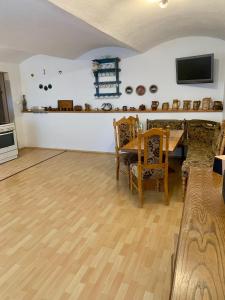 a living room with a wooden table and chairs at Foistovic Ranč in Staré Sedlo +18 photos