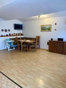 a living room with a table and chairs and a television at Foistovic Ranč in Staré Sedlo