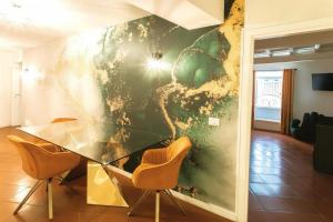 a dining room with a glass table and chairs at Le Clarisse Pigna Apartment in Rome +3 photos