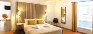 a bedroom with a large bed with yellow pillows at Le Clarisse Pigna Apartment in Rome