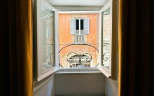 an open window with a view of a building at Le Clarisse Pigna Apartment in Rome