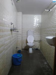 a bathroom with a toilet and a sink at Shreeji niwas in Varanasi